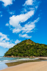 Fototapeta na wymiar View of Little peak covered by tropical jungle next to gorgeous desert beach in Brazil