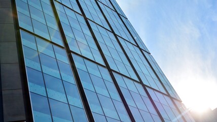 Bottom view of glass silhouette of skyscraper. Business building. Skyscraper with glass facade. Modern building in business district. Concepts of economics, financial, future.   