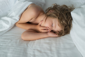 Obraz na płótnie Canvas Little kids boy sleeping on the bed. Kid sleep in bed.