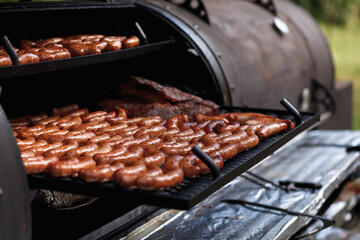 grilled sausages and steak on the grill