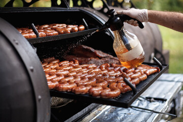 Grill man fries sausages