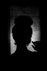 silhouette of a woman in a window