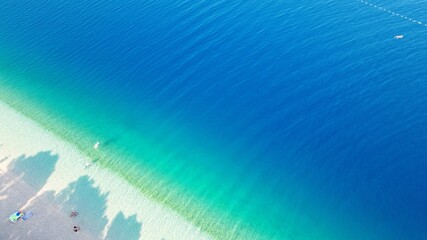 Beautiful Punta Rata beach in Brela, Croatia, aerial view. Adriatic Sea with amazing turquoise clean water and white sand on the beach. 