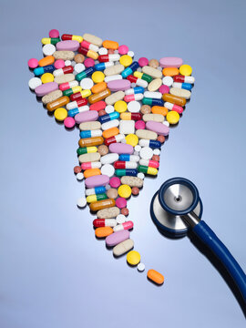 Stethoscope with pills in shape of South America
