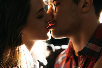 Close-up of a young romantic couple kissing and enjoying each other's company on the street