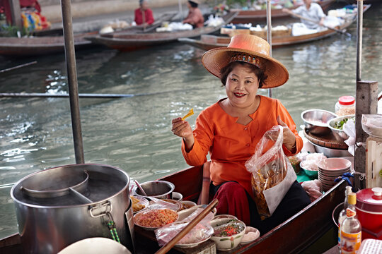 Portrait of mature female market stall holder, Damnoen Saduak Floating Market, Thailand