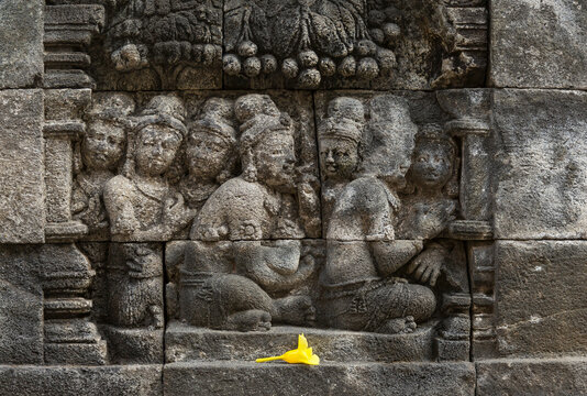 Flower offering and carvings, The Buddhist Temple of Borobudur, Java, Indonesia