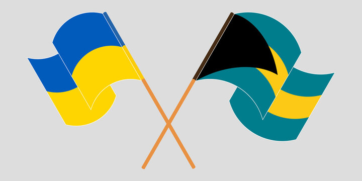 Crossed and waving flags of Bahamas and the Ukraine