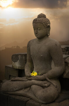 Flower offering and buddha, The Buddhist Temple of Borobudur, Java, Indonesia