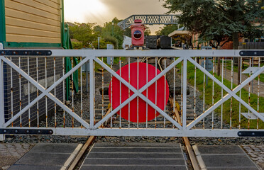 Fototapeta na wymiar Closed railway gate on the trainline