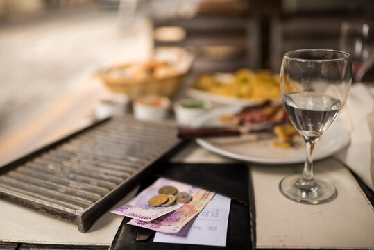 Restaurant bill and payment on table of traditional Parrilla, San Telmo, Buenos Aires, Argentina
