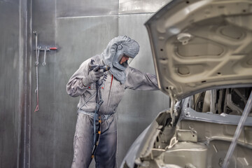 employee body painting workshop carries out painting of the internal elements of the car.