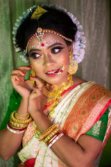 a girl in her marriage day adjusting her jewelry