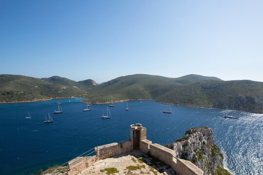 View of yachts and sea from castle on cliffs, Cabrera National Park, Cabrera, Balearic Islands, Spain