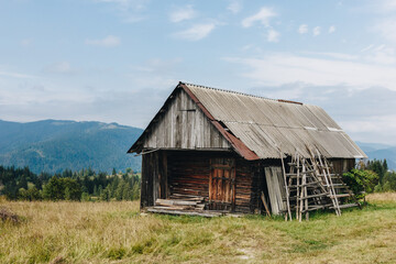 Picturesque mountain landscape with old wooden house