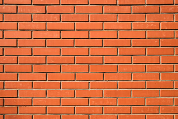 Red brick wall. Background of a new brick house. Perfect smooth brickwork.