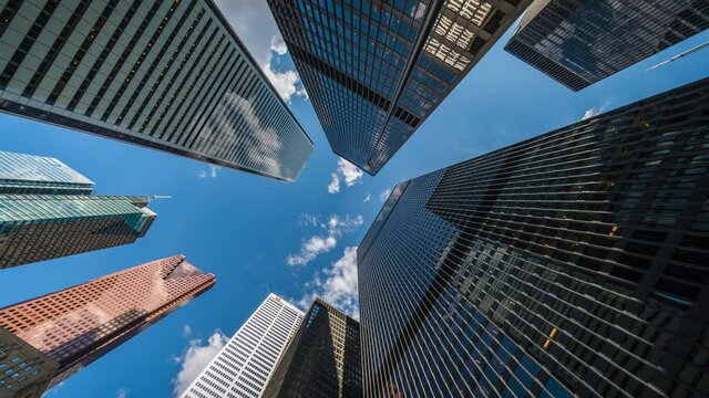 Business and finance concept, zoom out time lapse view looking up at office building architecture in the financial district, Toronto, Ontario, Canada.