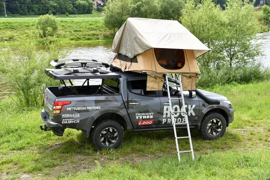 Mitsubishi L200 camper. Pickup in a camping setting in nature by