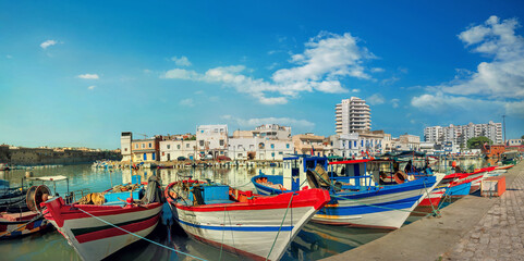 Fototapeta na wymiar Landscape with fishing boats at old port in Bizerte. Tunisia, North Africa