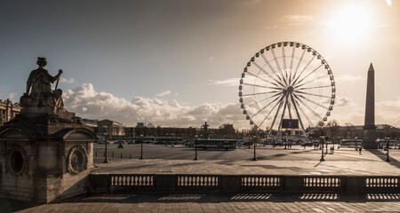 Silhouetted statue and Grande Roue ferris wheel at dusk, Paris, France