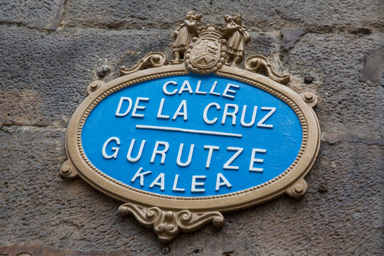 Low angle view of ornate street sign on stone wall. Bilba, Spain