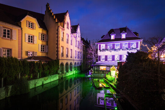 Floodlit canal and christmas lights at night, Little Venice, Colmar, France