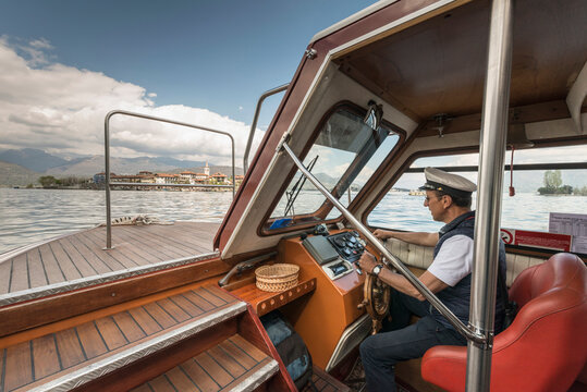 Captain driving tour boat, Lago Maggiore, Isole Borromee, Isola dei Pescatori, Borromean Islands