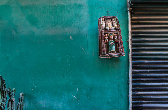 Religious wall hanging on colourful wall, Tijuana, Baja California, Mexico