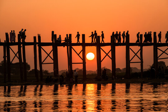People walking over Bein Bridge at sunset, Amarapura, Mandalay, Myanmar