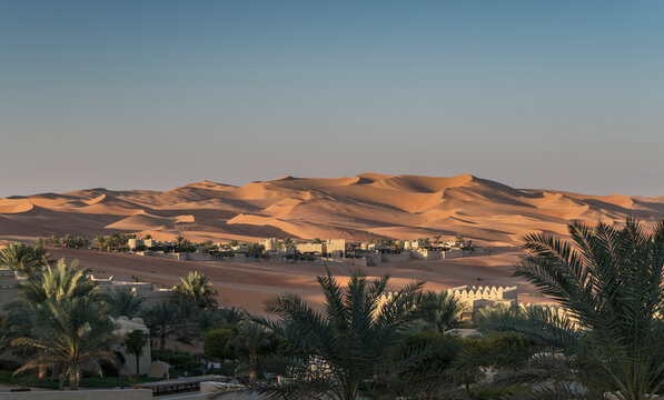 Distant view of Qsar Al Sarab desert resort among sand dunes, Empty Quarter Desert, Abu Dhabi, United Arab Emirate