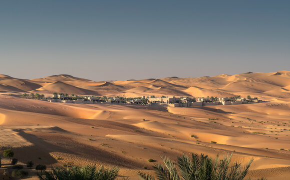 Distant view of Qsar Al Sarab desert resort among sand dunes, Empty Quarter Desert, Abu Dhabi, United Arab Emirate