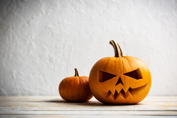 Two pumpkins on wooden table. Halloween and autumn food background