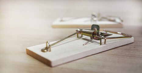 mousetraps without bait on a wooden table, as a business concept
