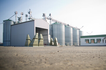 Construction of a feed mill agro-processing plant for processing and silos for drying cleaning and storage of agricultural products, flour, cereals and grain view from a ground. © Евгений Гвоздев
