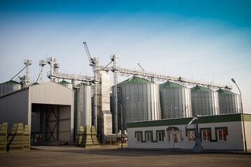 Construction of a feed mill agro-processing plant for processing and silos for drying cleaning and storage of agricultural products, flour, cereals and grain. Close-up. © Евгений Гвоздев