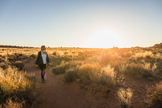 Woman hiking through Arches national Park, Moab, Utah, USA