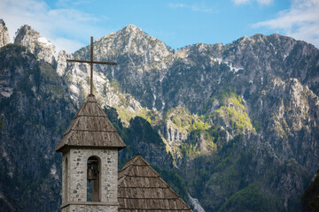 Village church bell tower and Accursed Mountains, Theth, Tirana, Albania