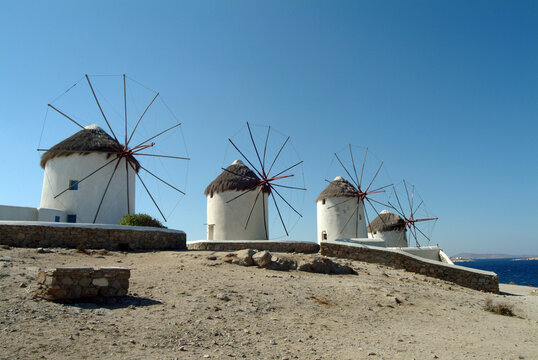 Row of traditional windmills on beach, Mykonos, Cyclades, Greece