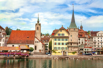 View of historic buildings, chapel and footbridge on Reuss river in Lucerne, Switzerland