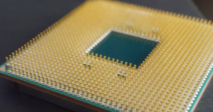 Close up on the connector pins of a multi threaded gaming pc cpu chip before being placed in the motherboard.