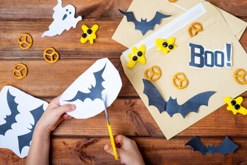 preparation for Halloween, cutting out decor for Halloween.