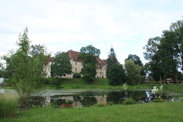 Naklejka na ściany i meble The old beautiful Jaunpils castle is landmark in the territory of Latvia on summer day 2020
