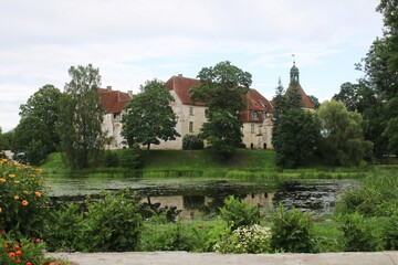Naklejka na ściany i meble The old beautiful Jaunpils castle is landmark in the territory of Latvia on summer day 2020