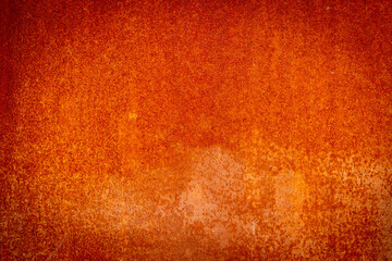 Reddish rusty metal wall with vignette for use as a background