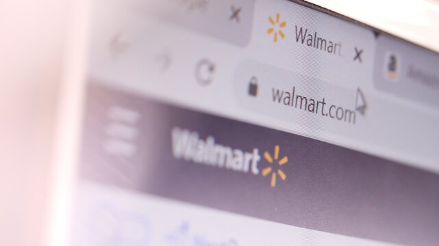 Walmart domain name in browser and logo on the computer screen. Editorial macro shot