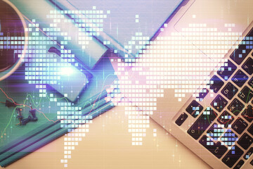 Business theme hologram drawings over computer on the desktop background. Top view. Multi exposure. Concept of international connections.