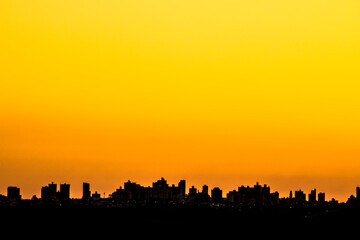 Fototapeta na wymiar Silhouette of cityscaper buildings during a sunset in Brazil