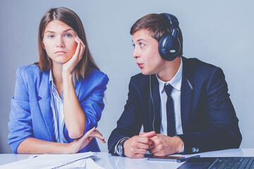 Portrait of female serious and male frivolous workers. Business, teamwork and conflict concept.