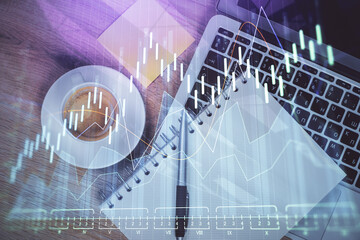Double exposure of forex chart drawing over table background with computer. Concept of financial research and analysis. Top view.