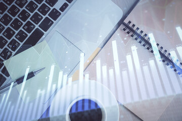 Stock market graph and top view computer on the table background. Double exposure. Concept of...